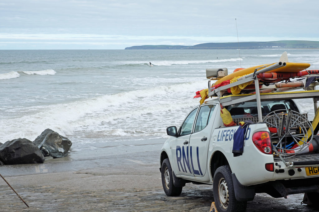 WESTWARD HO, ENGLAND SEPTEMBER 20, 2016: Surfers on the Devon coast are protected by the Royal National Lifeboat Institution, a 190 year old charity providing lifeguard cover for 180 British beaches